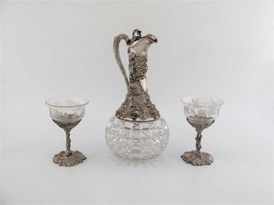 Appraisal: A Victorian cut glass mounted claret jug with a slender