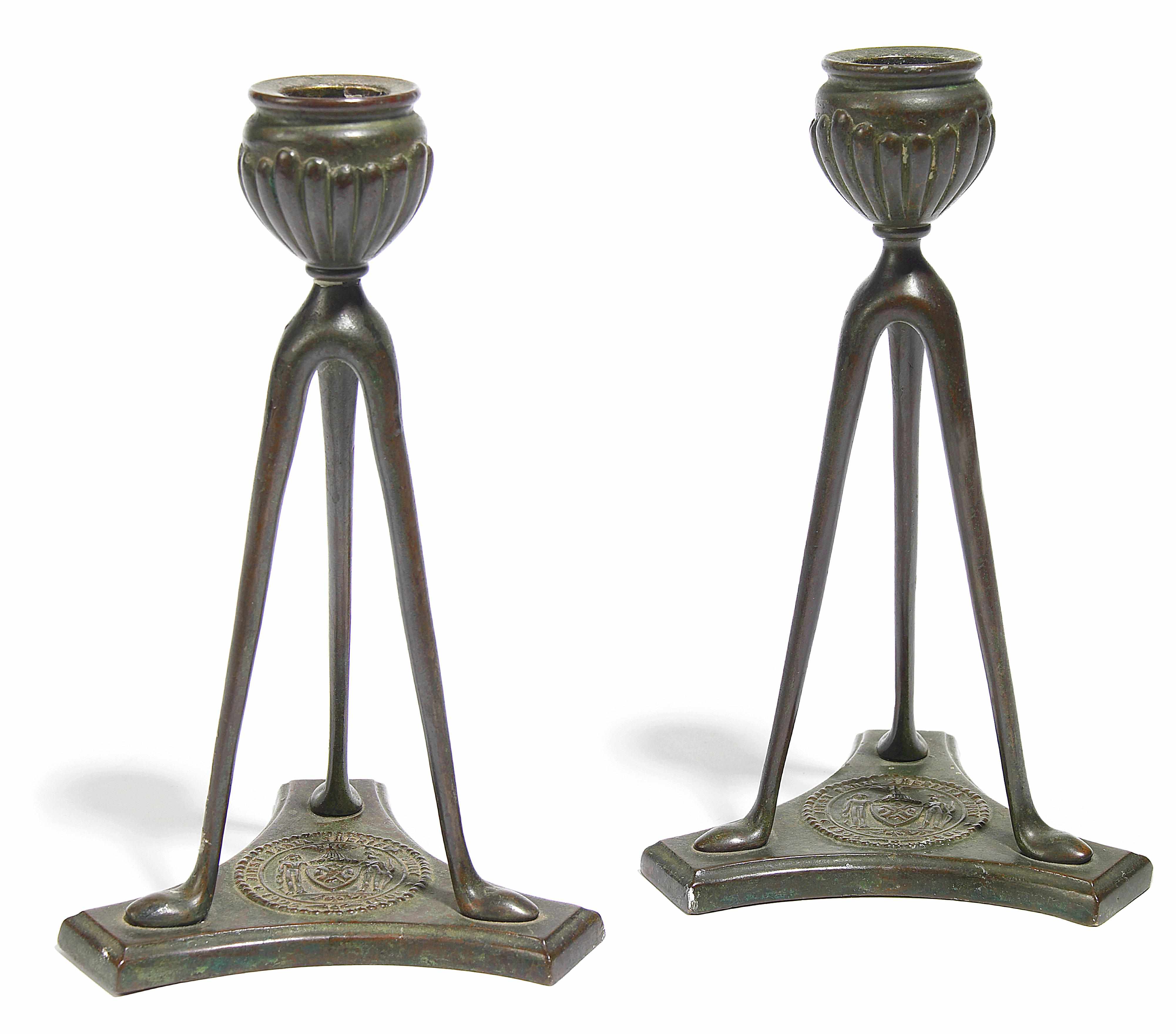 Appraisal: A pair of Tiffany Studios patinated bronze tripartite candlesticks -