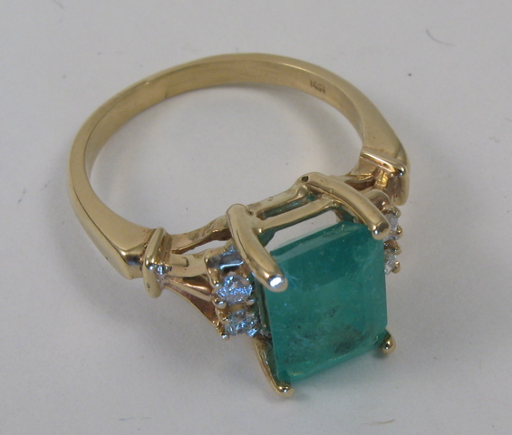 Appraisal: EMERALD AND FOURTEEN KARAT GOLD RING centering an emerald-cut green