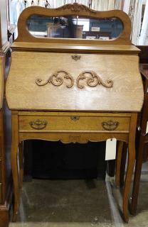 Appraisal: American golden oak secretary circa having a shaped mirrored top