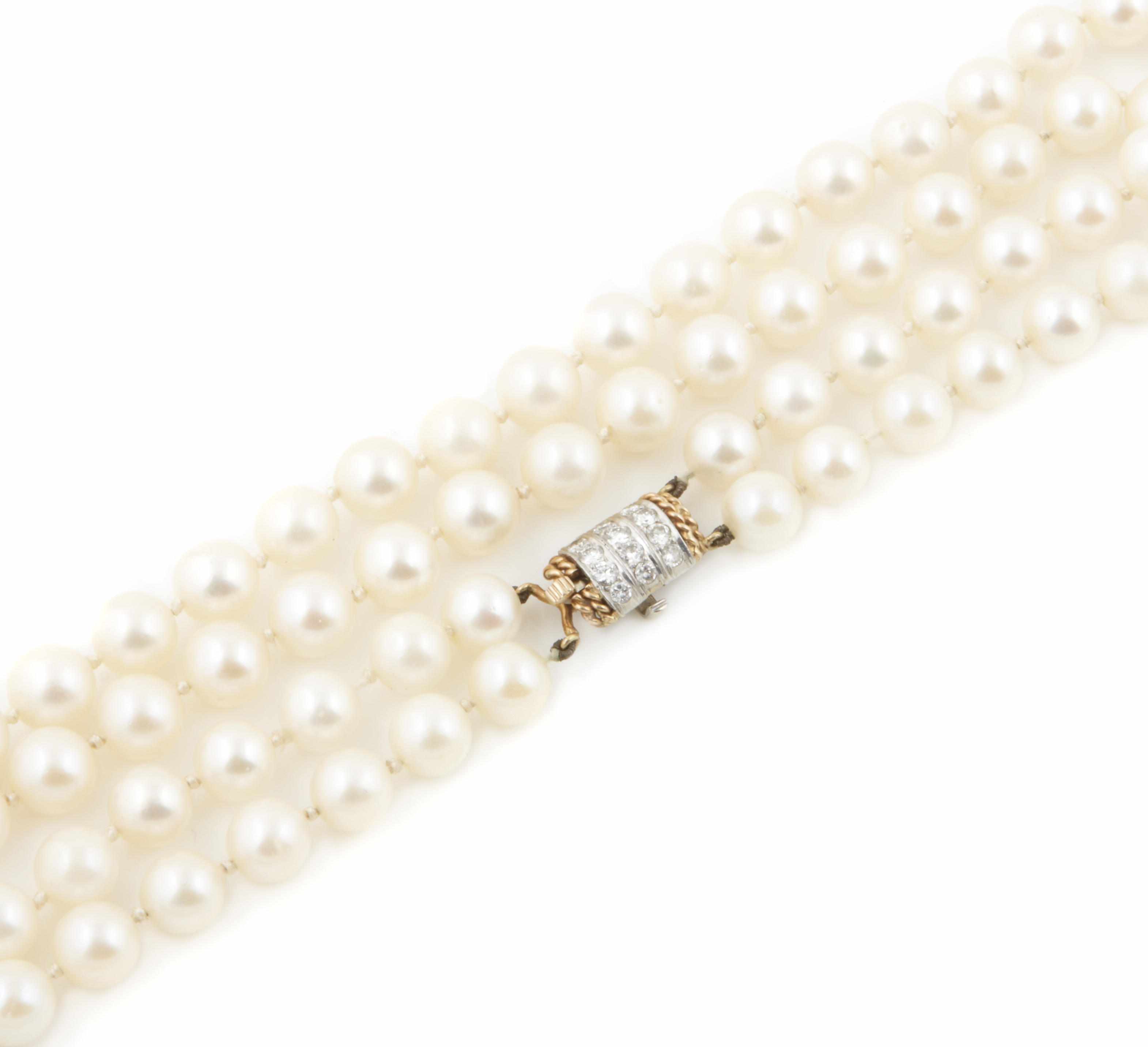 Appraisal: A double strand of cultured pearls with diamond and gold