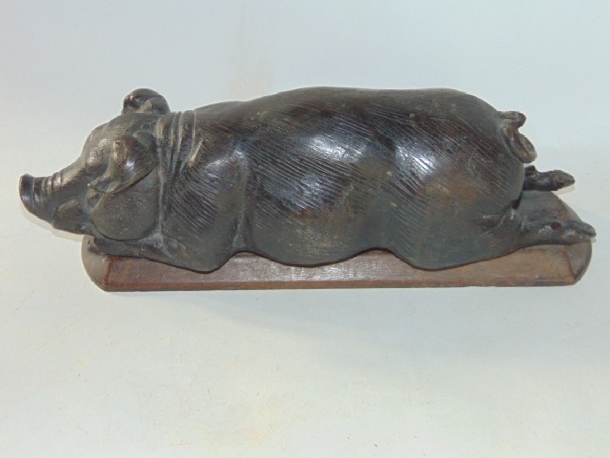 Appraisal: A well modelled cast metal study of a recumbent hog