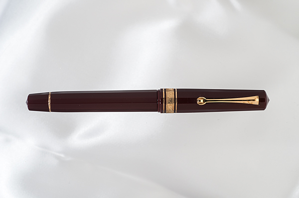 Appraisal: Omas Extra celluloid gold fountain pen Dark red celluloid with