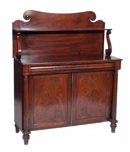 Appraisal: A REGENCY MAHOGANY CHIFFONIER the raised panel scroll back having