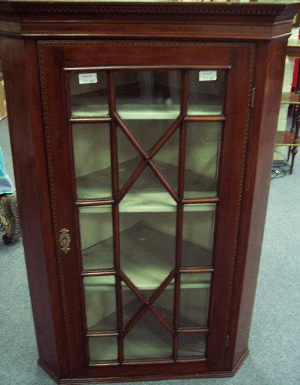 Appraisal: An early th Century mahogany corner cupboard with dentil cornice