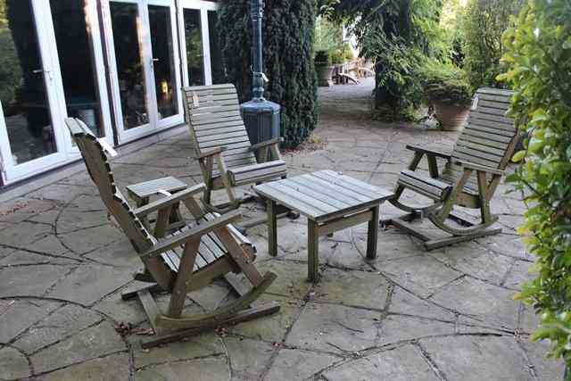 Appraisal: THREE ROCKING GARDEN ARMCHAIRS together with a small square table