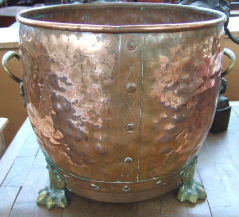 Appraisal: A copper circular log bin with brass handles and lion