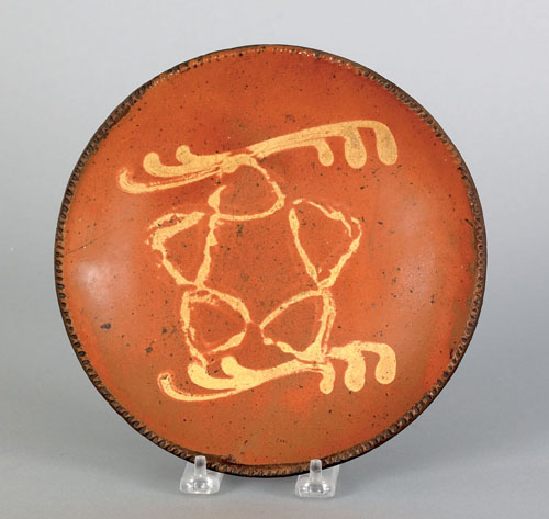 Appraisal: American redware plate th c with yellow slip star decoration