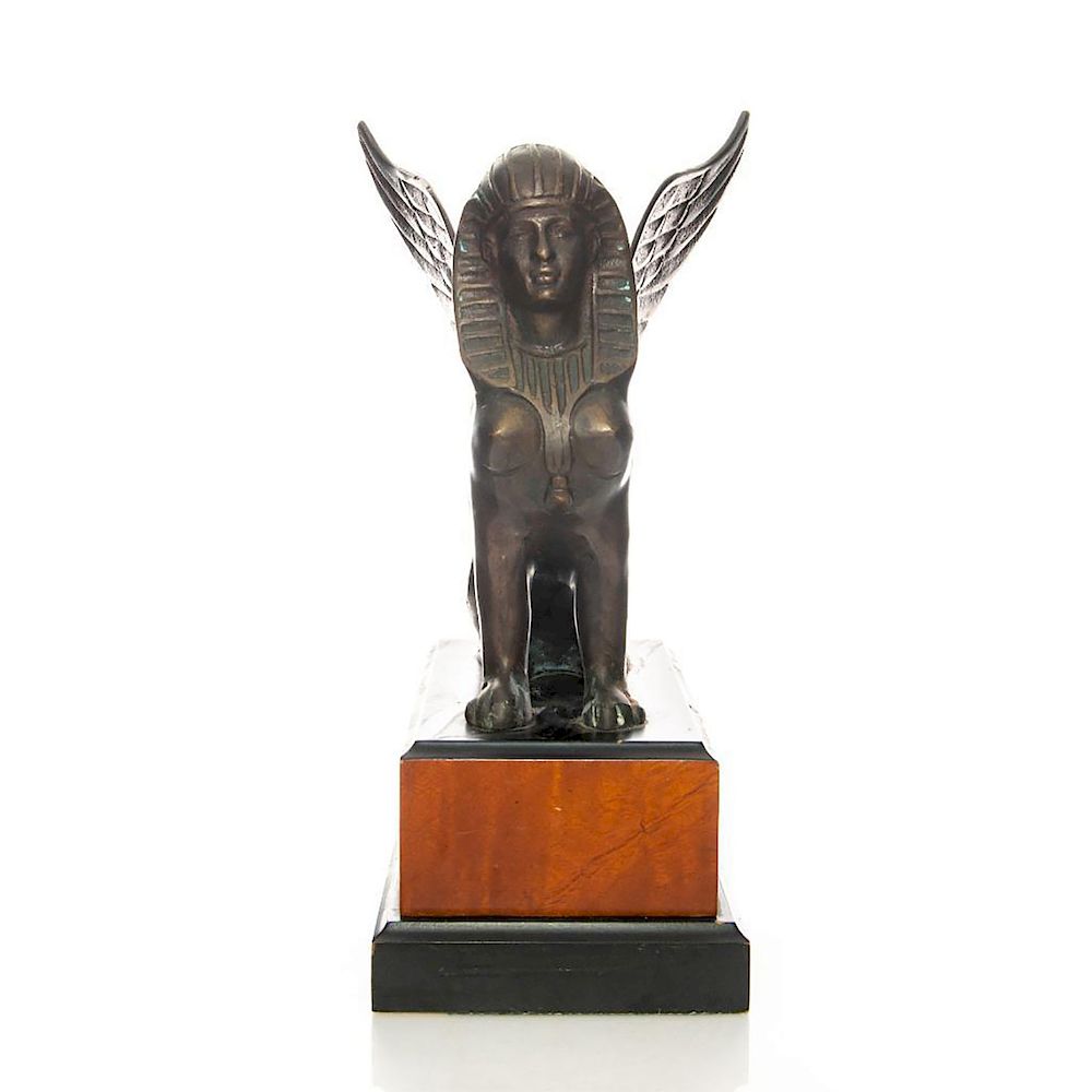 Appraisal: BRONZE SPHINX STATUE Seated with prominent wings Mounted on wood