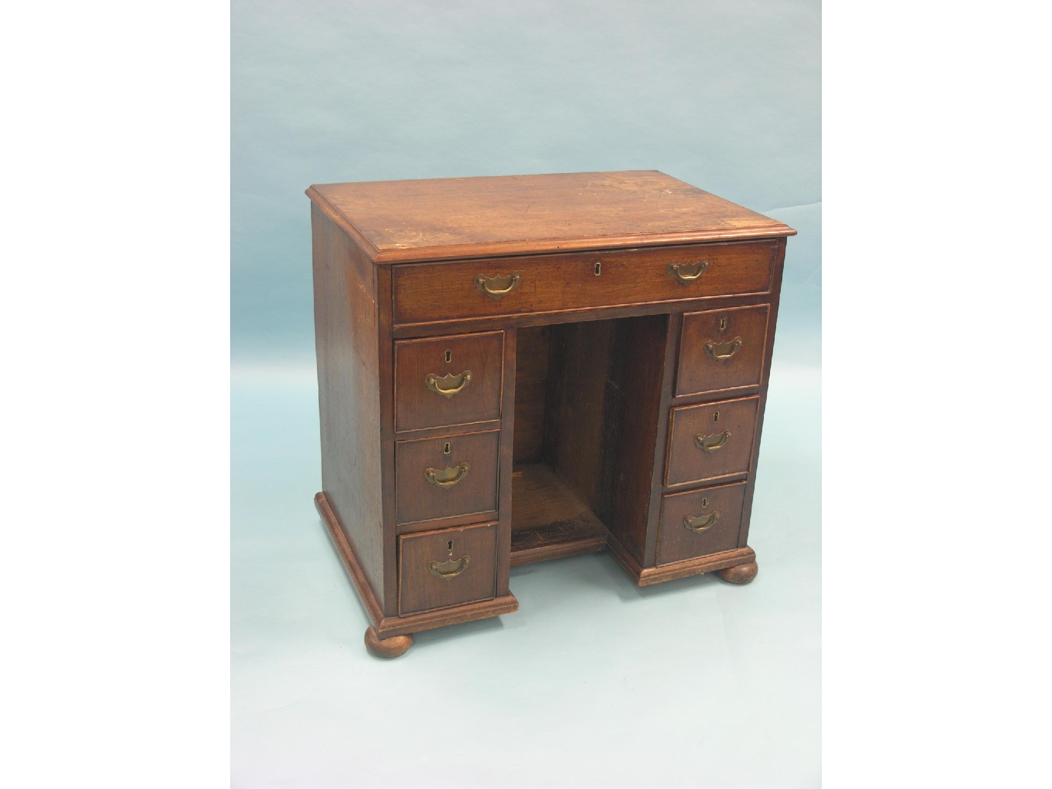 Appraisal: A George III mahogany kneehole desk one long and six