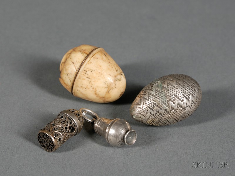 Appraisal: Four Personal Spice Containers th th century silver nut-form ivory