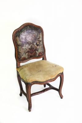 Appraisal: A Continental walnut framed chair with leather panel back serpentine