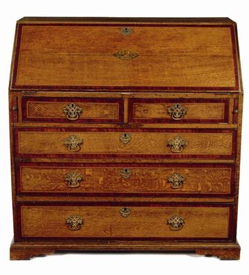 Appraisal: A George III oak bureau the later leather lined fall