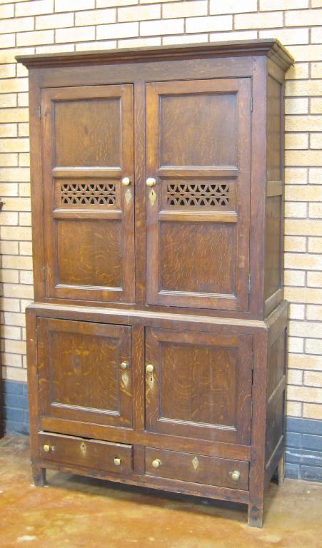 Appraisal: An antique oak Bread and Cheese Cupboard with two pairs