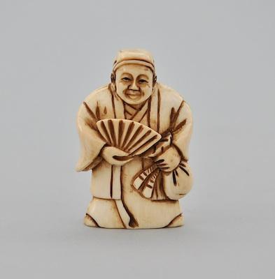 Appraisal: An Ivory Netsuke of A Man Holding a Fan A