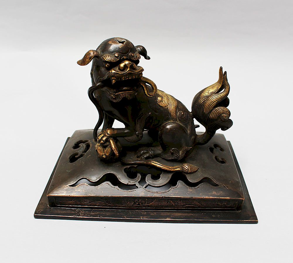 Appraisal: Chinese Bronze Fo Lion Chinese Bronze male Fo Lion with