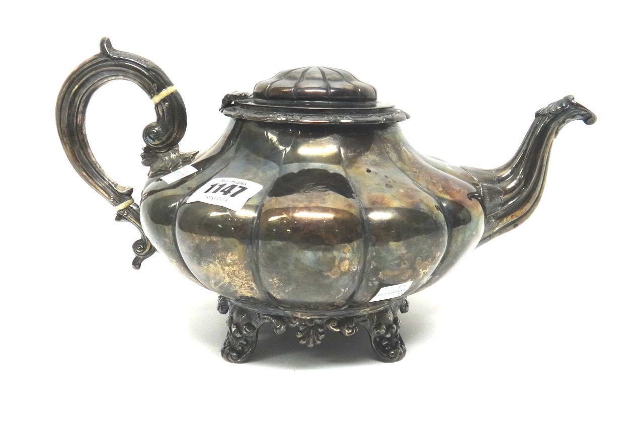 Appraisal: An Irish silver large teapot of squat melon fluted form