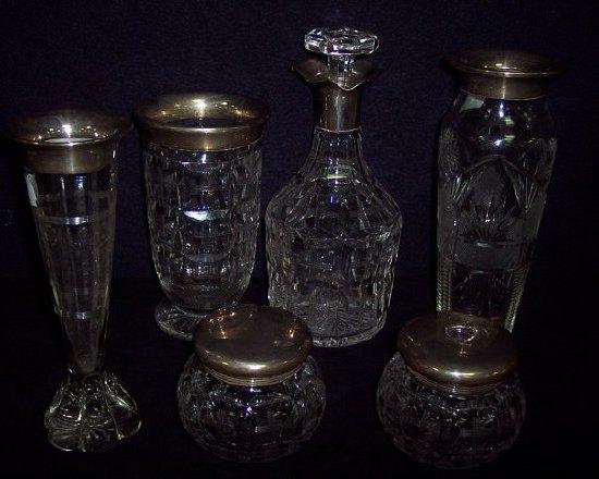 Appraisal: A silver mounted cut glass decanter with triple pourer three