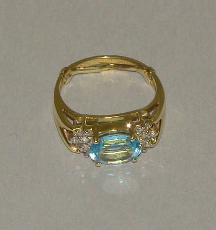 Appraisal: LADY'S OVAL BLUE TOPAZ AND DIAMOND RING The karat yellow