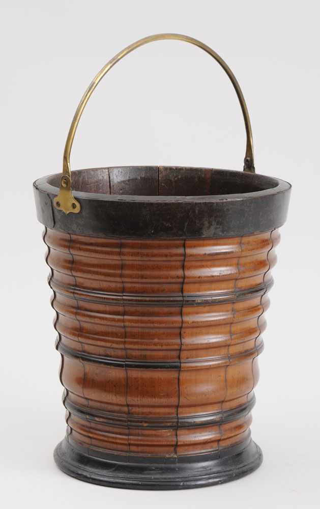 Appraisal: ENGLISH BRASS-MOUNTED TURNED WOOD BUCKET The tapered and ringed bowl