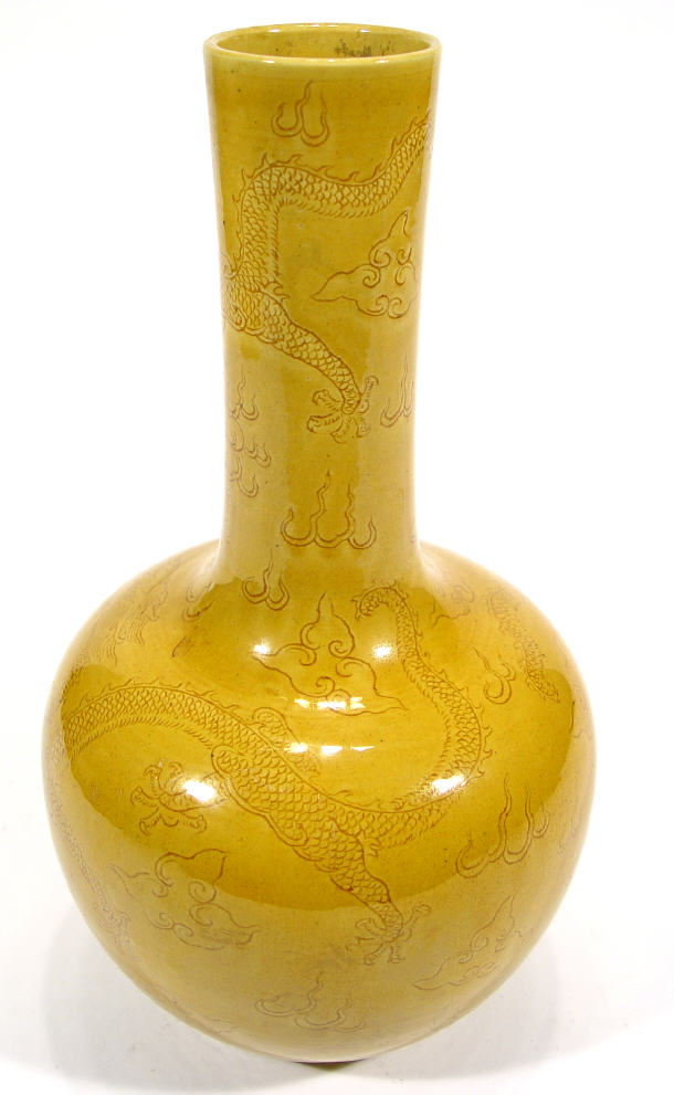 Appraisal: Chinese pottery bottle vase incised with dragons under a amber