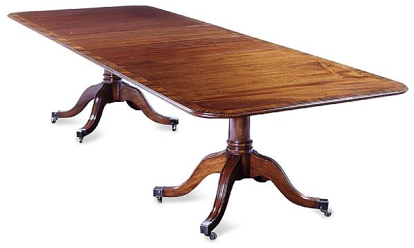 Appraisal: A Georgian style mahogany dining table The elongated crossbanded top