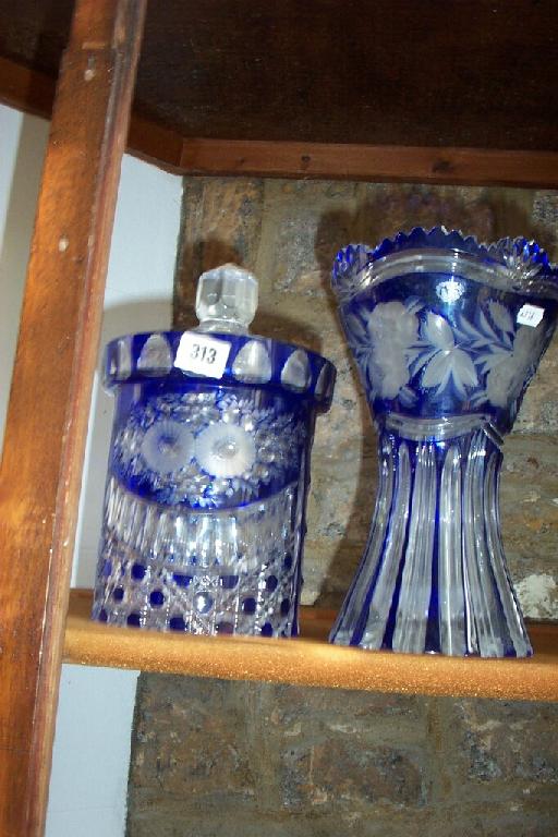 Appraisal: A cut glass biscuit barrel and cover with blue overlaid