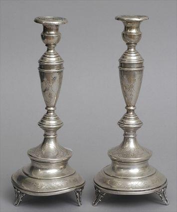 Appraisal: PAIR OF AUSTRIAN ENGRAVED SILVER CANDLESTICKS Each slender urn stem