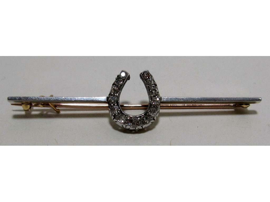 Appraisal: Edwardian bi colour gold diamond set horseshoe bar brooch