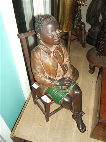 Appraisal: A th Century plaster figure of a young boy sitting