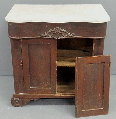 Appraisal: Victorian marble top cabinet with a carved drawer and scrolled