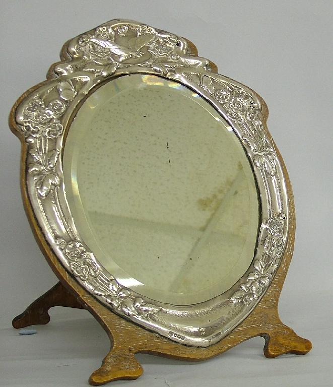 Appraisal: Art Nouveau oak and silver applied oval easel dressing mirror