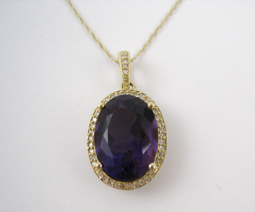 Appraisal: FOURTEEN KARAT GOLD DIAMOND AND AMETHYST PENDANT the approximately ct