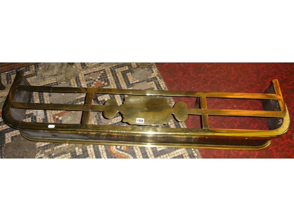 Appraisal: A Victorian polished brass and iron fender