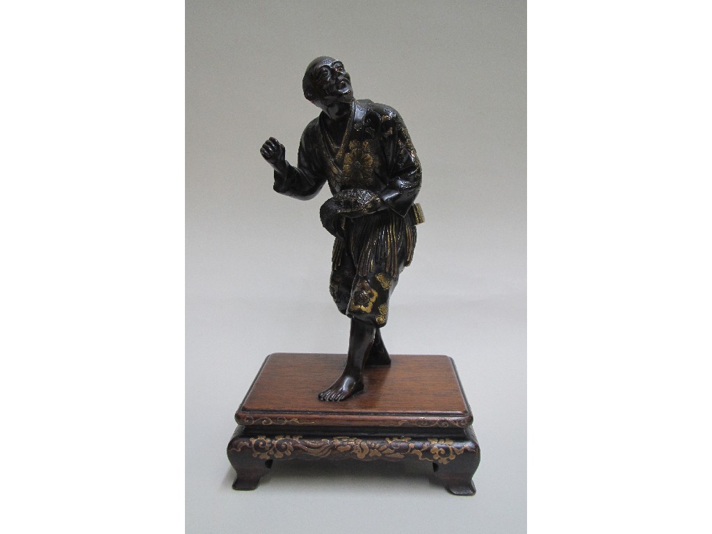 Appraisal: A Japanese bronze model of a hunter holding a turtle