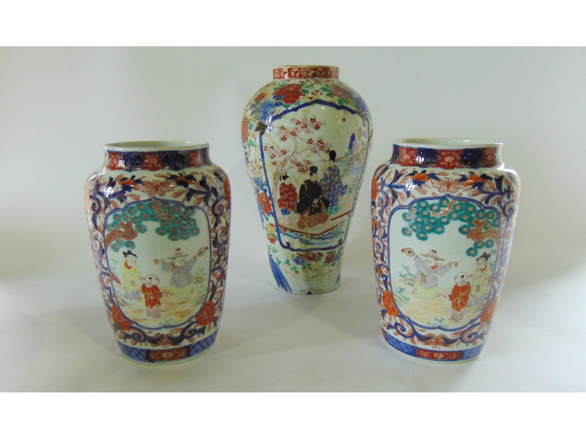 Appraisal: A pair of late th century Imari vases tapering cylindrical