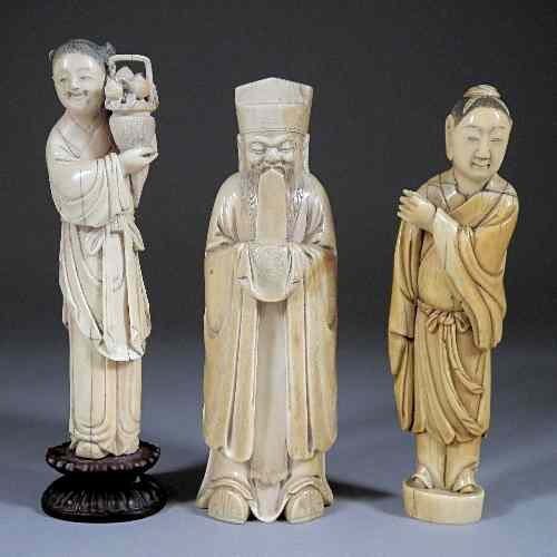 Appraisal: A Chinese carved ivory standing figure of a Maiden holding