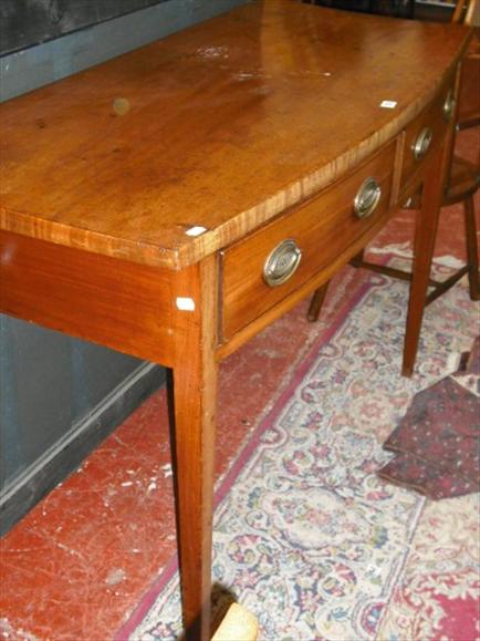 Appraisal: A George III and later bowfront mahogany serving table