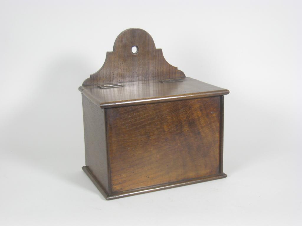 Appraisal: An oak Candle Box with shaped back and hinged cover