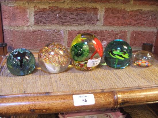 Appraisal: A COLLECTION OF FIVE DECORATIVE GLASS PAPERWEIGHTS with varying flower