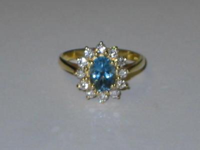 Appraisal: AN AQUAMARINE AND DIAMOND CLUSTER RING the oval cut aquamarine