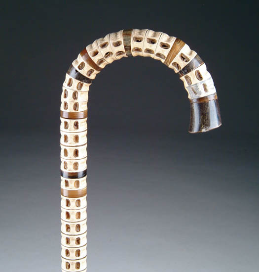 Appraisal: CURVED HANDLE VERTEBRAE CANE Horn tip and end with eight