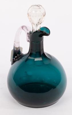 Appraisal: A blue tinted glass claret jug and stopper cm high