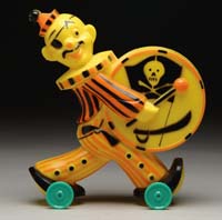 Appraisal: HALLOWEEN PIRATE BANK ON WHEELS Plastic yellow pirate with orange