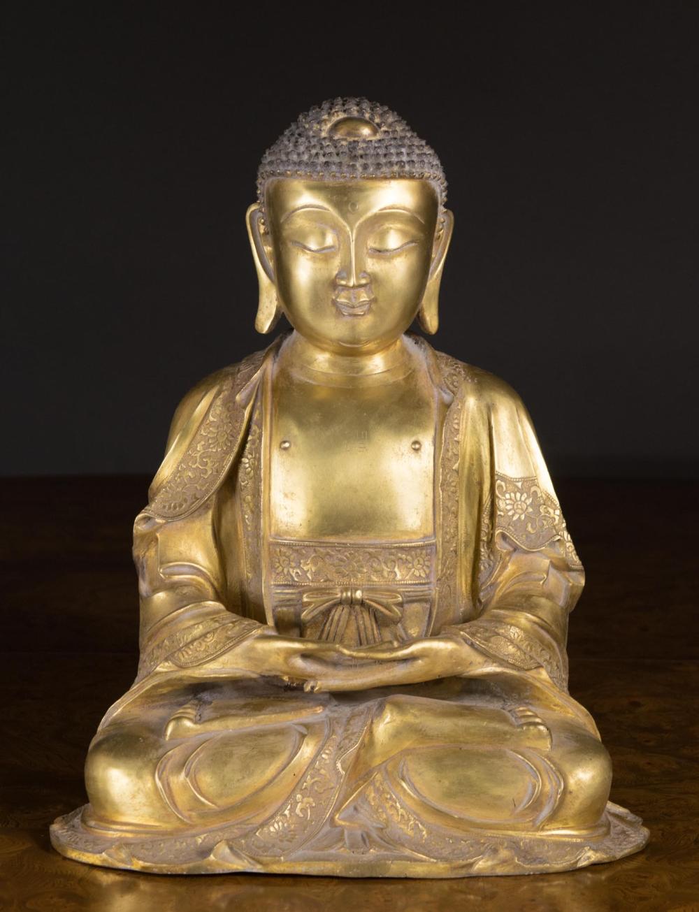 Appraisal: CHINESE GILT BRONZE BUDDHA SCULPTURE depicting a seated Buddha with