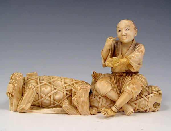 Appraisal: CARVED IVORY MAN SEATED ON A DOCK Signed in characters