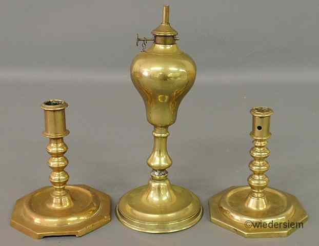 Appraisal: Two similar Continental brass candlesticks th c with octagonal bases