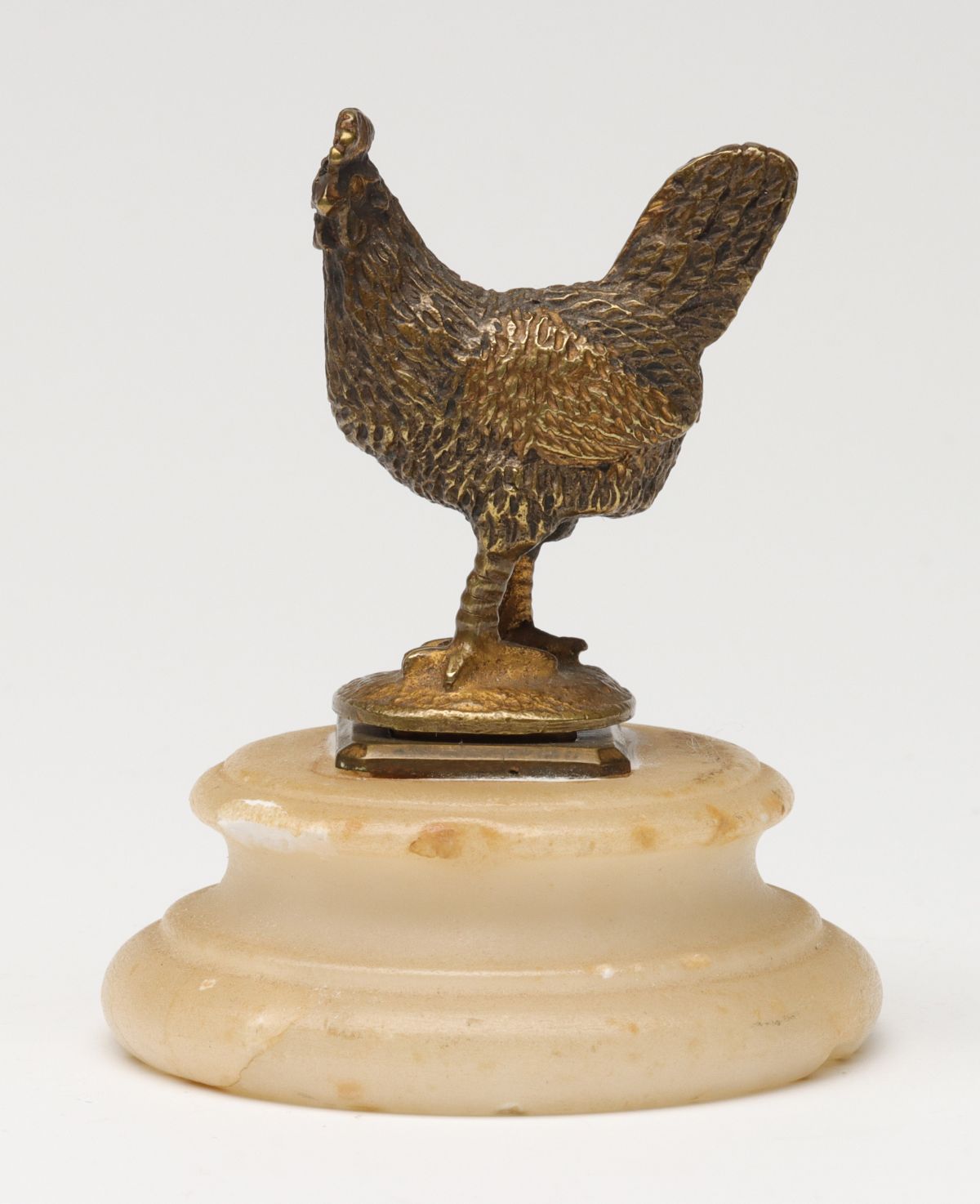 Appraisal: A BRASS FIGURAL ROOSTER WAX SEAL IN ALABASTERThe brass sealer