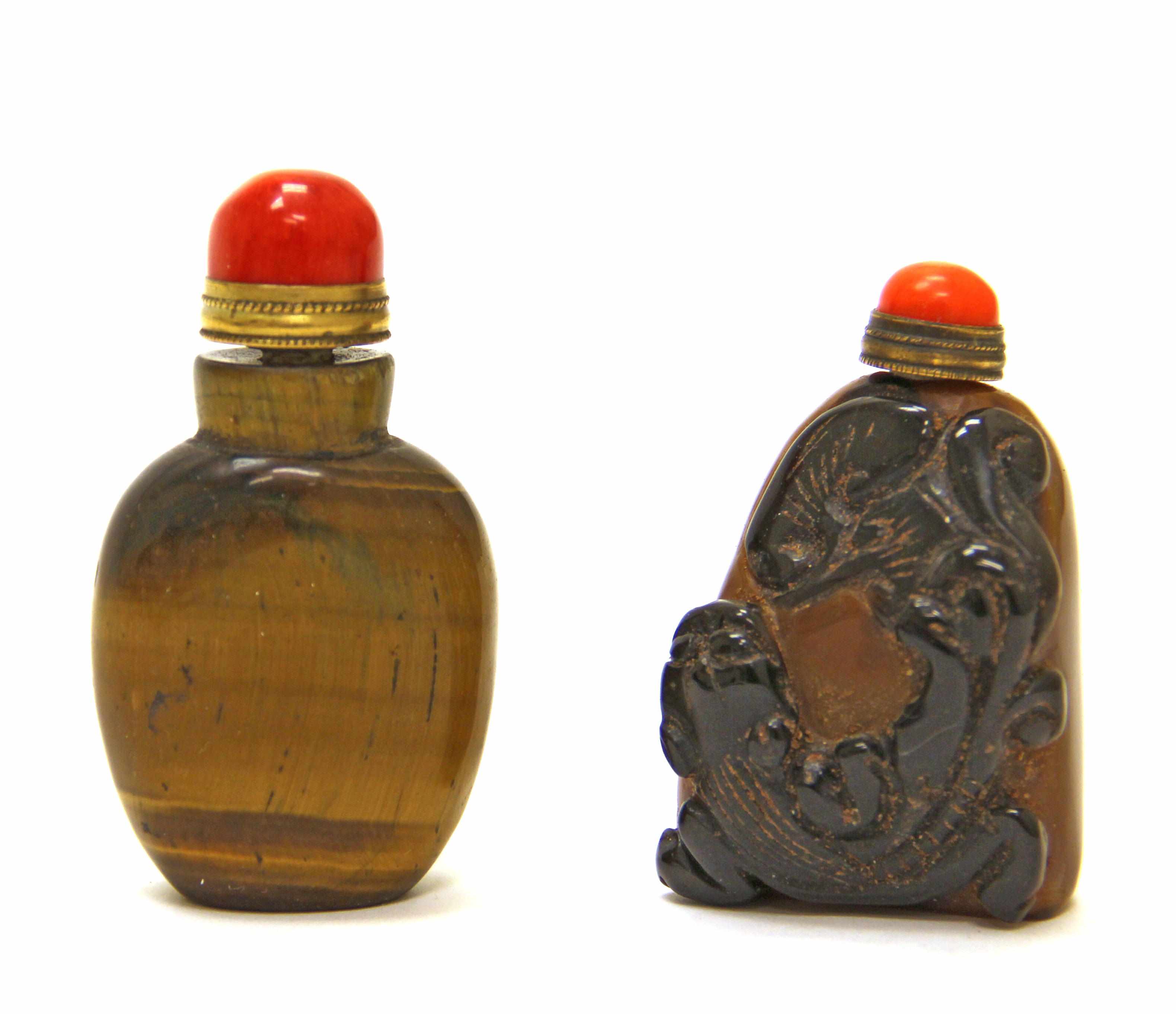 Appraisal: Two carved stone snuff bottles The first of horizontally striated