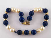 Appraisal: A cultured pearl and lapis lazuli bracelet with yellow metal